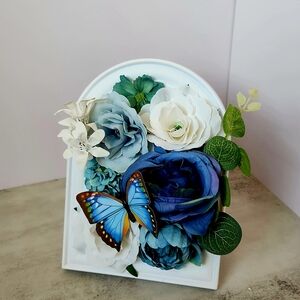 Charming Blue and White Floral Display with Butterfly